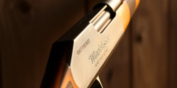 Detailed shot of a 32WIN rifle highlighting its vintage design and craftsmanship, perfect for firearms enthusiasts and collectors.